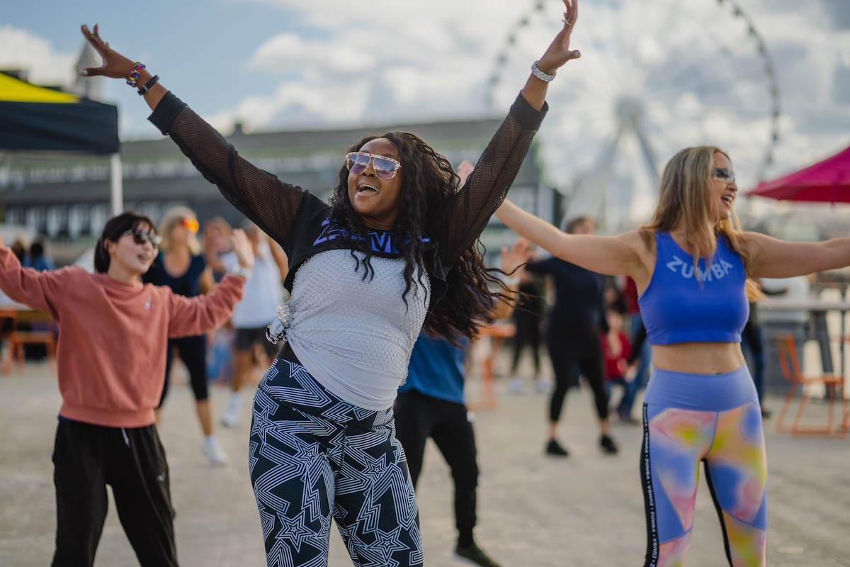 A group participates in a Zumba class on Pier 62. 